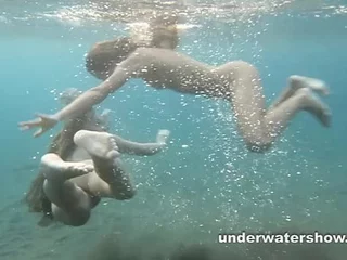 Julia plus Masha are swimming unadorned less along to congeries